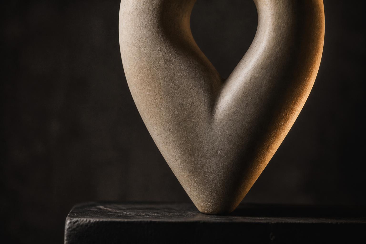 Abstract still life: a sculpted stone form tapering to a refined narrow line, standing in for jaw contour treatment.