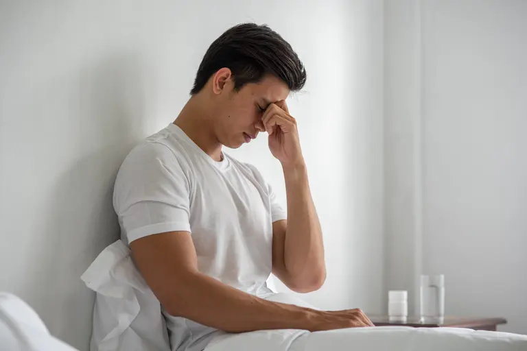 Fatigued man illustrating symptoms of iron deficiency assessed at a Singapore clinic