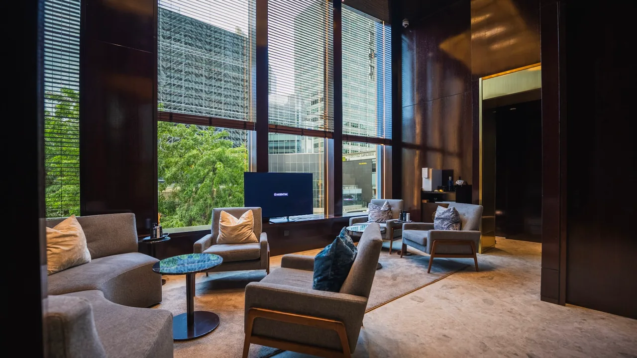 Hisential Orchard Clinic patient lounge with floor-to-ceiling windows overlooking Orchard Road, Singapore